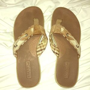 Worn sperry leather and plaid flip flops